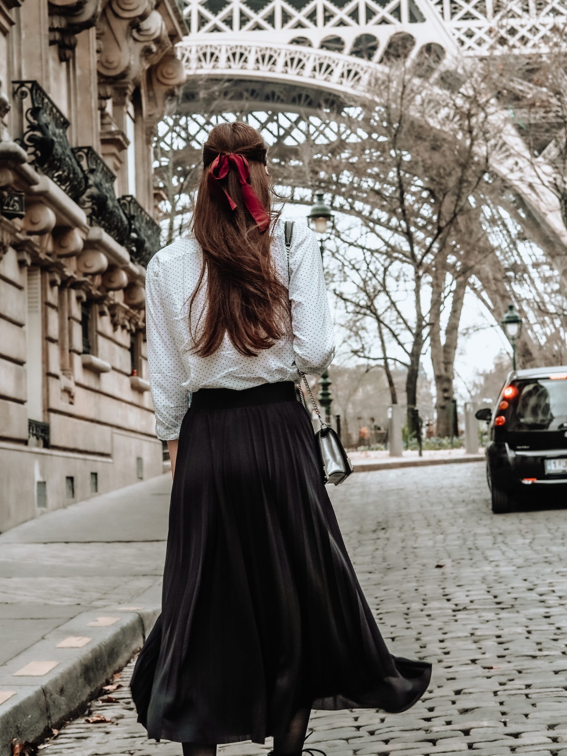 Girl wanders Paris red bow